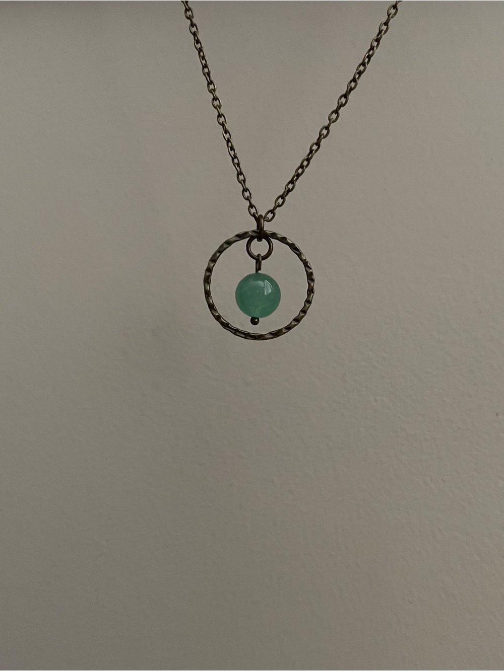 Brass crimped hoop steel green aventurine gemstone necklace.